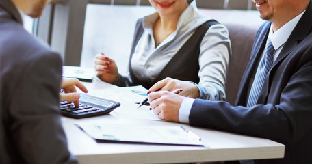 Portrait of smart business partners communicating at meeting