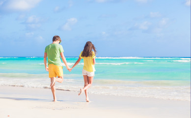 back view of happy couple at the beach