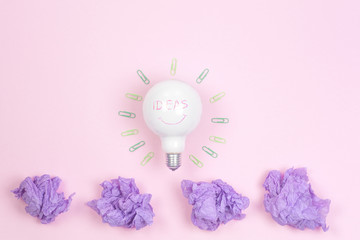 great idea concept with crumpled colorful paper and light bulb on light background