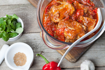 Baked chicken fricassee with chili and pepper.