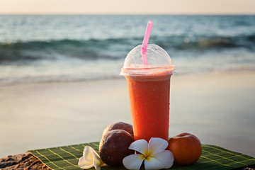 beautiful smoothie on the beach  at sunset.