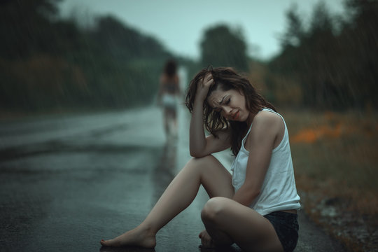 Woman crying in the rain.