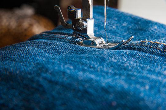 Foot Of Sewing Machine On Jeans