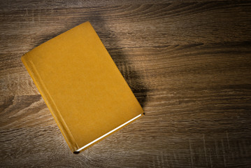 Yellow book on the table - 105384675