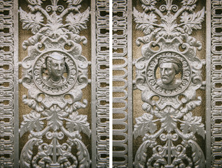 Vintage metallic door detail with two faces of a woman and a men - circa 19th century