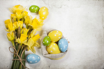 Easter backgound off painted eggs and yellow flowers