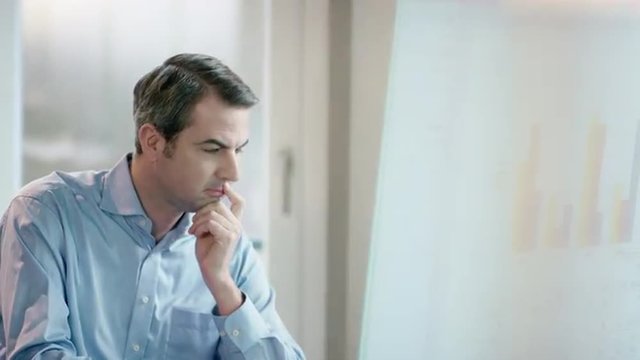 business man at office desk concentratedly thinking