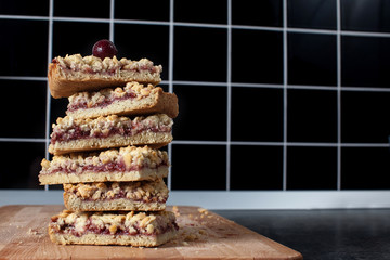.cup of cappuccino with homemade pastries pie raspberry jam and berries on a wooden board.