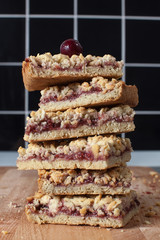 .cup of cappuccino with homemade pastries pie raspberry jam and berries on a wooden board.