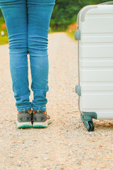 Young asian woman travel alone on the road focused at travel bag, Travel concept.