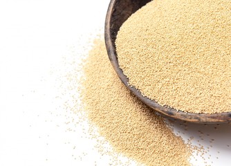 Amaranth seeds in rustic wooden bowl isolated