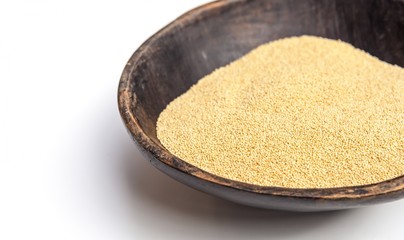 Amaranth seeds in rustic wooden bowl isolated