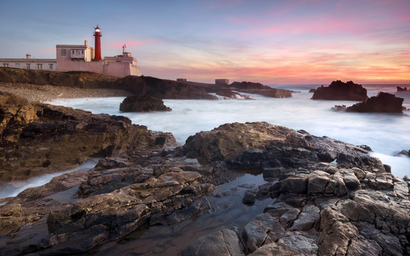 Sunset and a beautiful lighthouse, twilight rocks