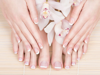 female feet at spa salon on pedicure and manicure procedure
