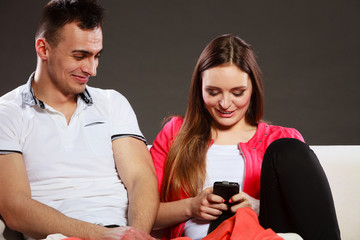 Couple using mobile phone texting messages