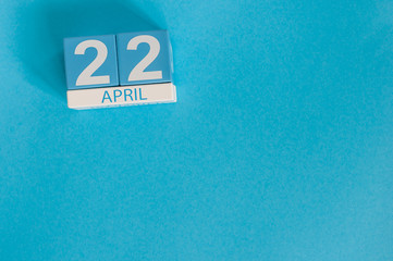 April 22nd. Earth Day. Image of april 22 wooden color calendar on blue background.  Spring day, empty space for text