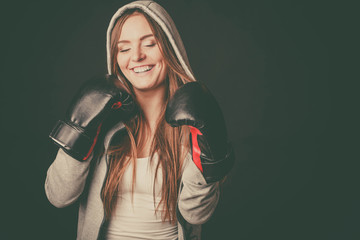 Happy woman wear hoodie and boxer gloves.