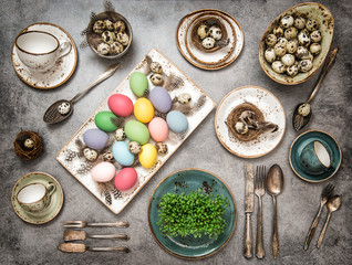 Fototapeta na wymiar Table place setting with colored easter eggs. Vintage style