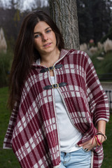 Blue-eyed young model posing in a fashion shoot in the park. 