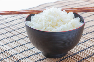 Cup of cooked rice with chopsticks, with clipping path.