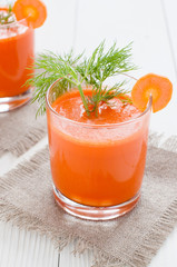 Glass of carrot juice on linen napkin