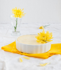 Cheesecake in ceramic bowl with yellow flowers