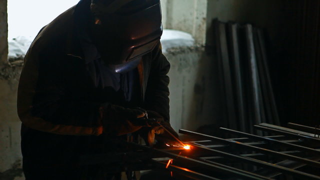 A welder is welding in winter