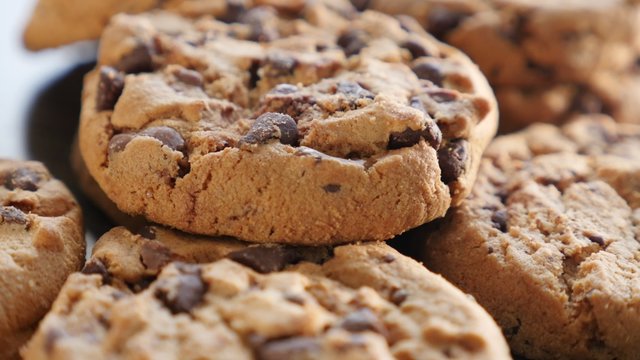 Tasty chocolate chip cake biscuits on the table slow tilt 4K 2160p UltraHD footage - Slow tilting on chocolate cookies on wooden surface 4K 3840X2160 UHD video