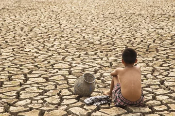 Fototapeten A lone children in the  arid area © bannafarsai
