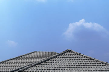 Fototapeta na wymiar Roof house with tiled roof on blue sky