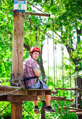 adventure climbing high wire park - people on course in mountain