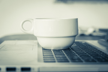 coffee cup put on laptop