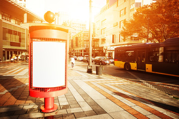 blank billboard on cityroad through modern buildings