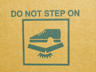 "do not step on" warning symbol on real cardboard box