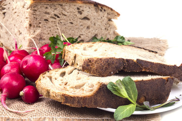 cut pieces of black bread of scattered near the radish on sackin
