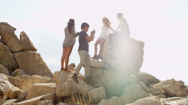 Friends climbing on rocks