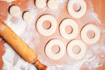The pastry chef prepares the donuts from dough