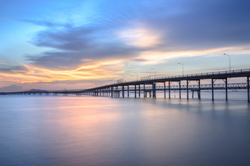 Fototapeta na wymiar Panorama scene of transportation cargo bridge to seaport along twilight sky at beautiful