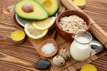Fresh avocado on cutting board over wooden background