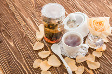 Tea cups with teapot on old wooden table