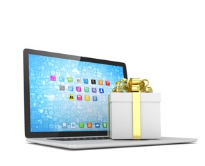 Gift box with ribbon bow on laptop keyboard