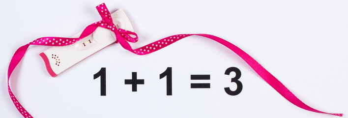 Pregnancy test with positive result wrapped ribbon on white background, expecting for baby