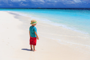 little boy looking at tropical beach