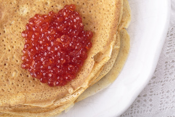 Homemade crepes with red caviar