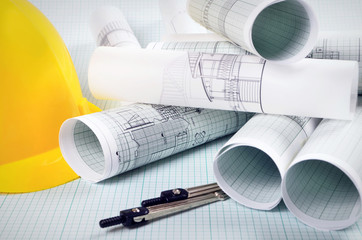 Architectural project of graph paper and yellow helmet