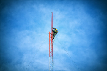 Repairman working on communications tower