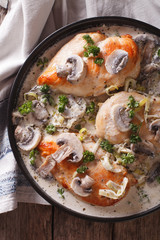 Chicken with mushroom sauce close-up on the table. vertical top view
