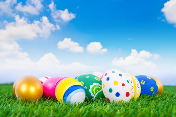 Fototapeta na wymiar Easter Eggs on Fresh Green Grass over blue sky
