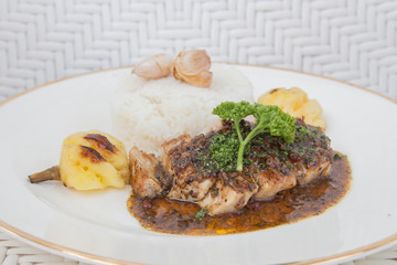 Roasted pepper pork served with rice and pineapple
