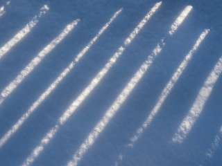 contrast striped background. shadows on snow